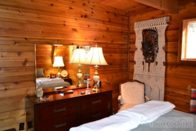 174 Deer Run Road Deep Gap, NC 28618 - Photo 5 of 35 a bed room with a bed and a night stand