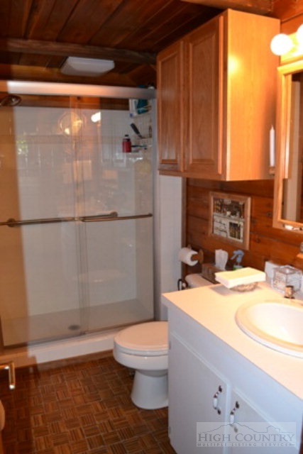 174 Deer Run Road Deep Gap, NC 28618 - Photo 8 of 35 a bathroom with a sink a toilet and shower