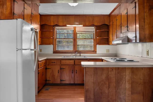 a kitchen with a refrigerator and a stove