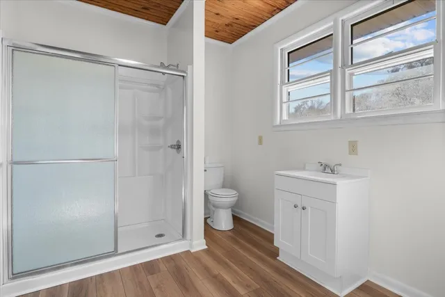 a view of an empty room with wooden floor