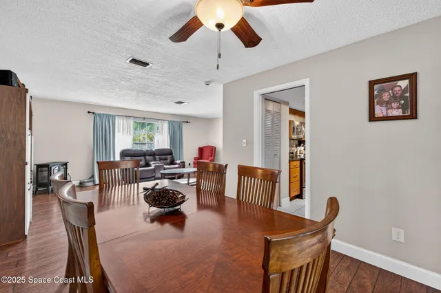 a kitchen with stainless steel appliances granite countertop a refrigerator a stove top oven and a sink