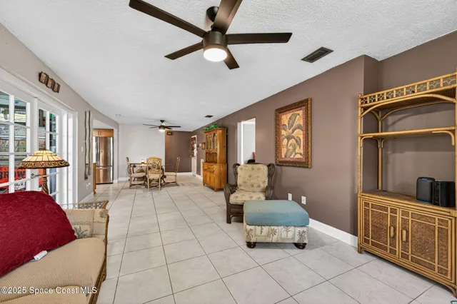 a bedroom with a bed a dresser with wooden floor