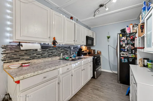 an aerial view of a house with a yard basket ball court