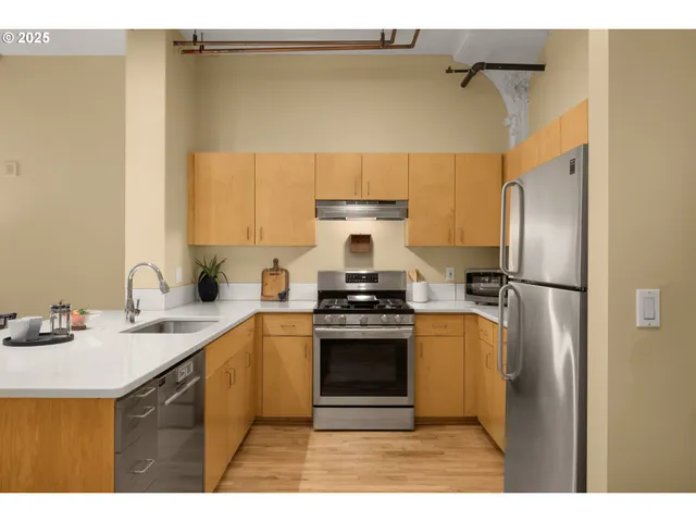 a kitchen with a sink stainless steel appliances and cabinets