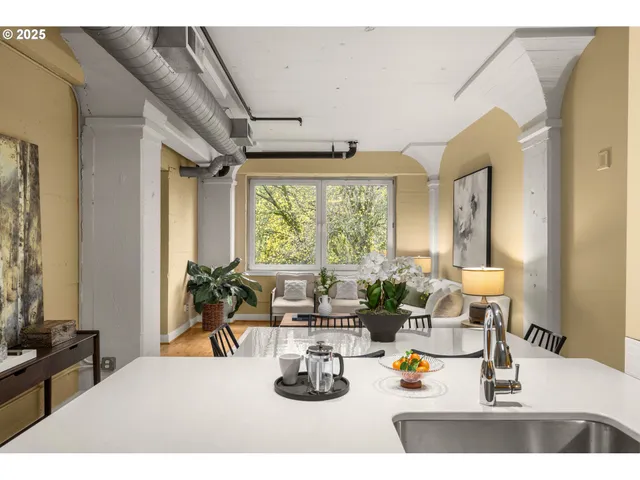 a kitchen with a large window and living room
