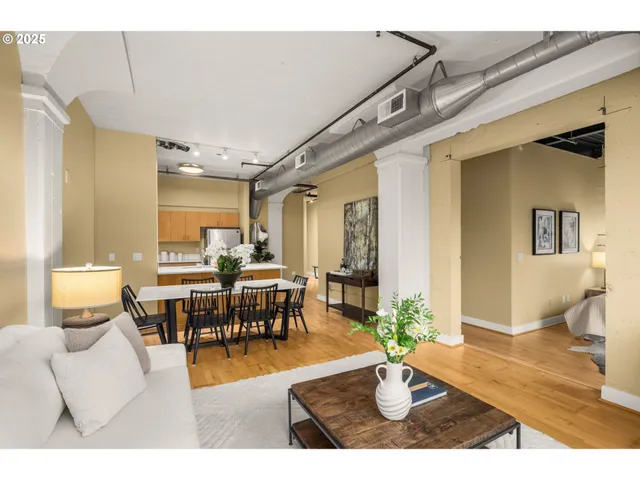 a living room with lots of furniture and a potted plant