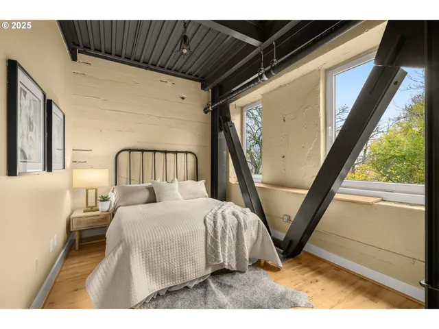 a bedroom with a bed and a large window