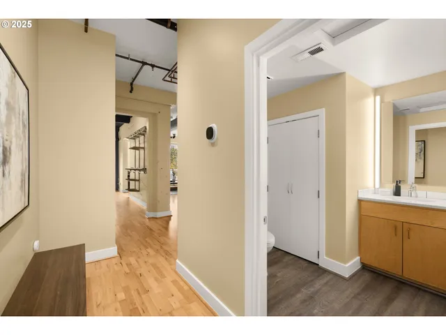 a hallway with wooden floor and windows