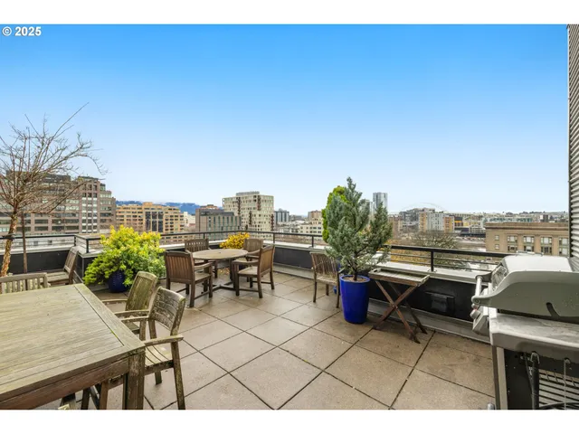 a terrace with outdoor seating and city view