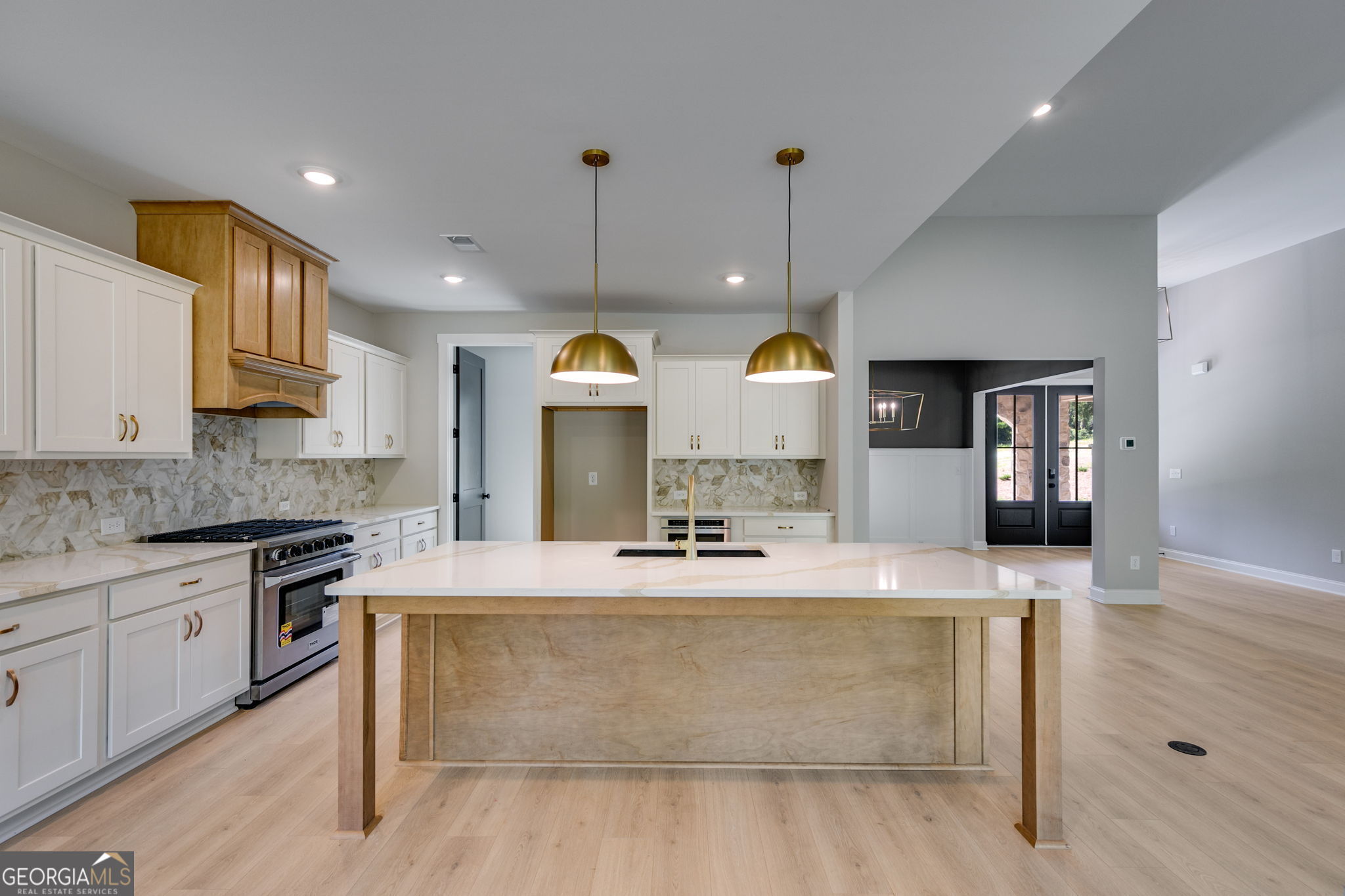 1575 Bethesda Church Road Carrollton, GA 30117 - Photo 17 of 46 a view of a kitchen with kitchen island a sink stainless steel appliances and a counter top space