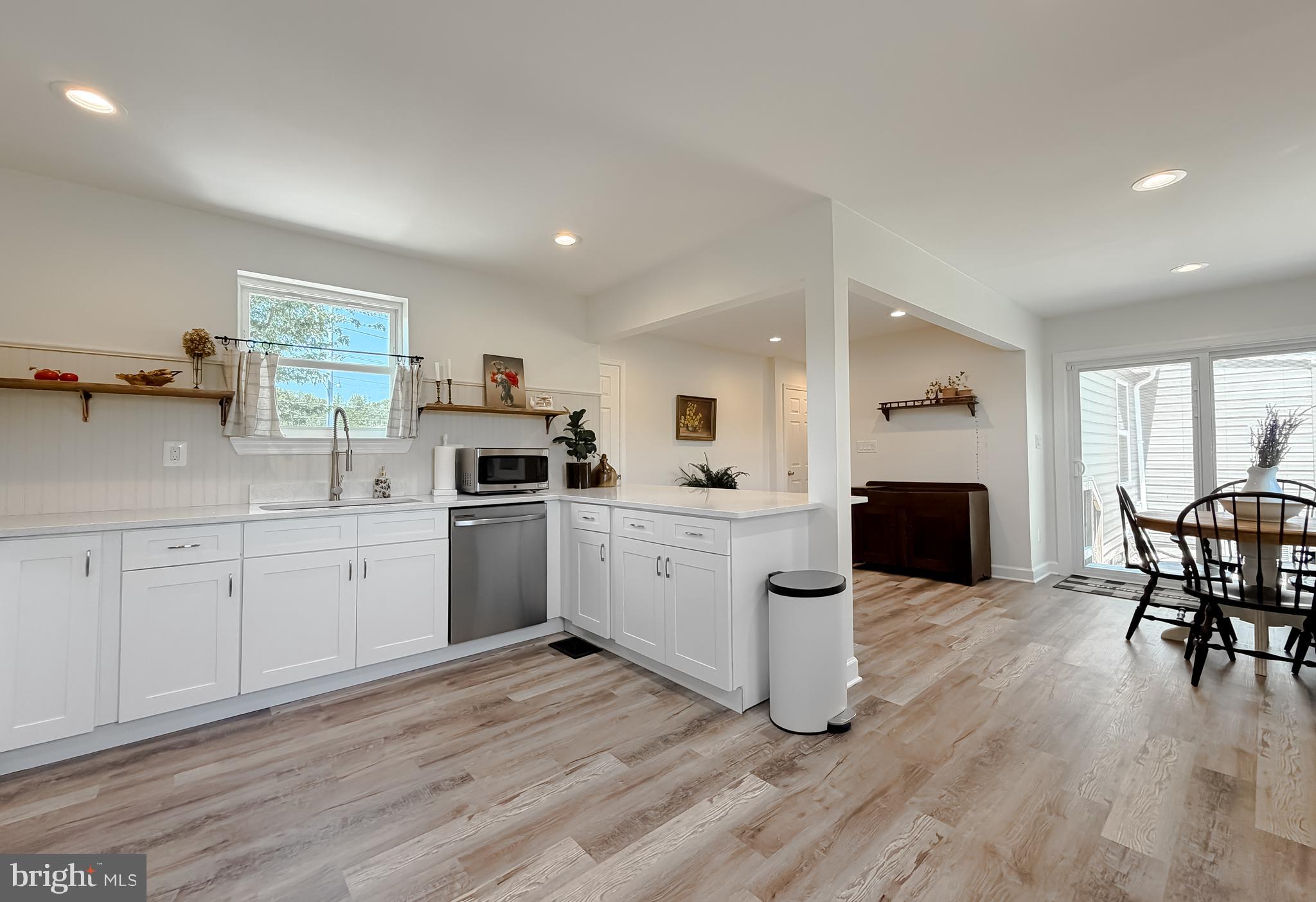 4985 Solomons Island Road Huntingtown, MD 20639 - Photo 7 of 50 a kitchen with sink cabinets and wooden floor