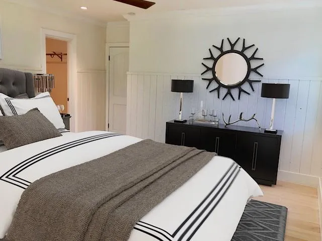 a bedroom with a bed and a chandelier