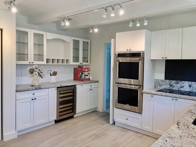 a kitchen with granite countertop a stove and a sink