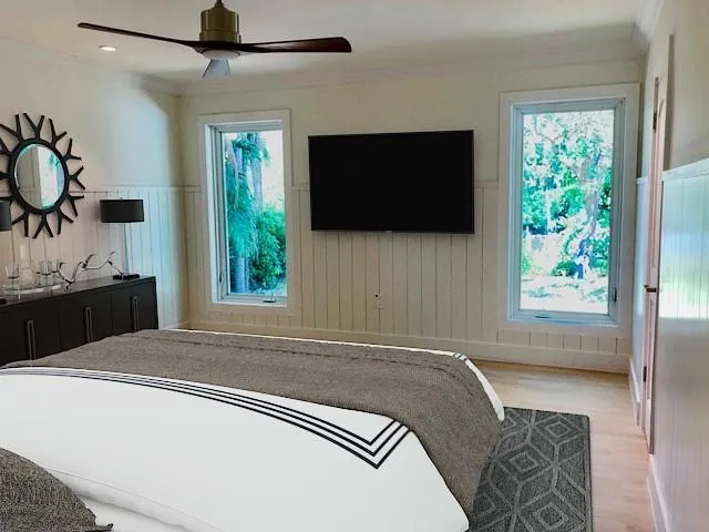 a living room with a bed furniture and a flat screen tv