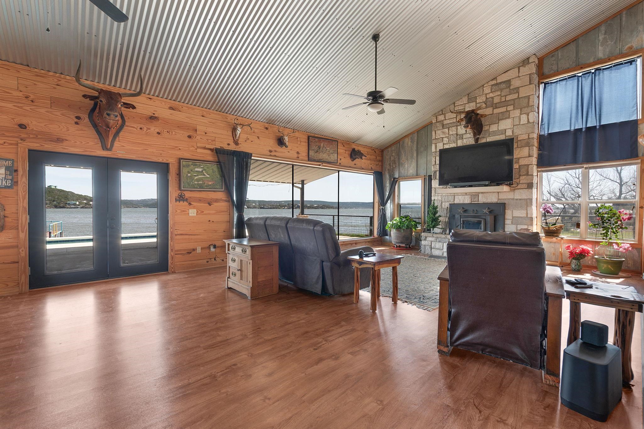 303 Lakeshore Loop Tow, TX 78672 - Photo 18 of 30 a living room with couches a flat screen tv and kitchen view