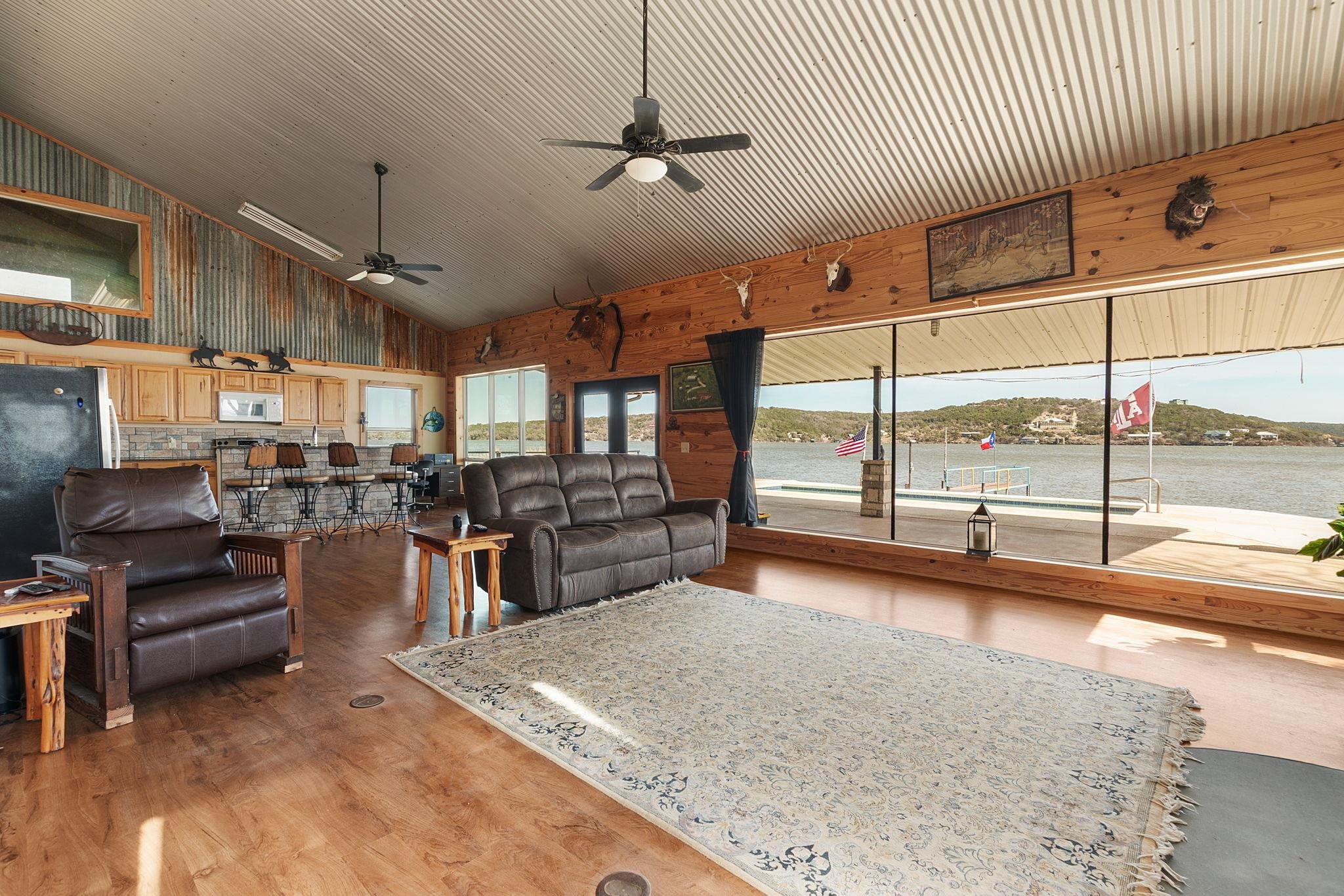 303 Lakeshore Loop Tow, TX 78672 - Photo 19 of 30 a living room with lots of furniture and a chandelier