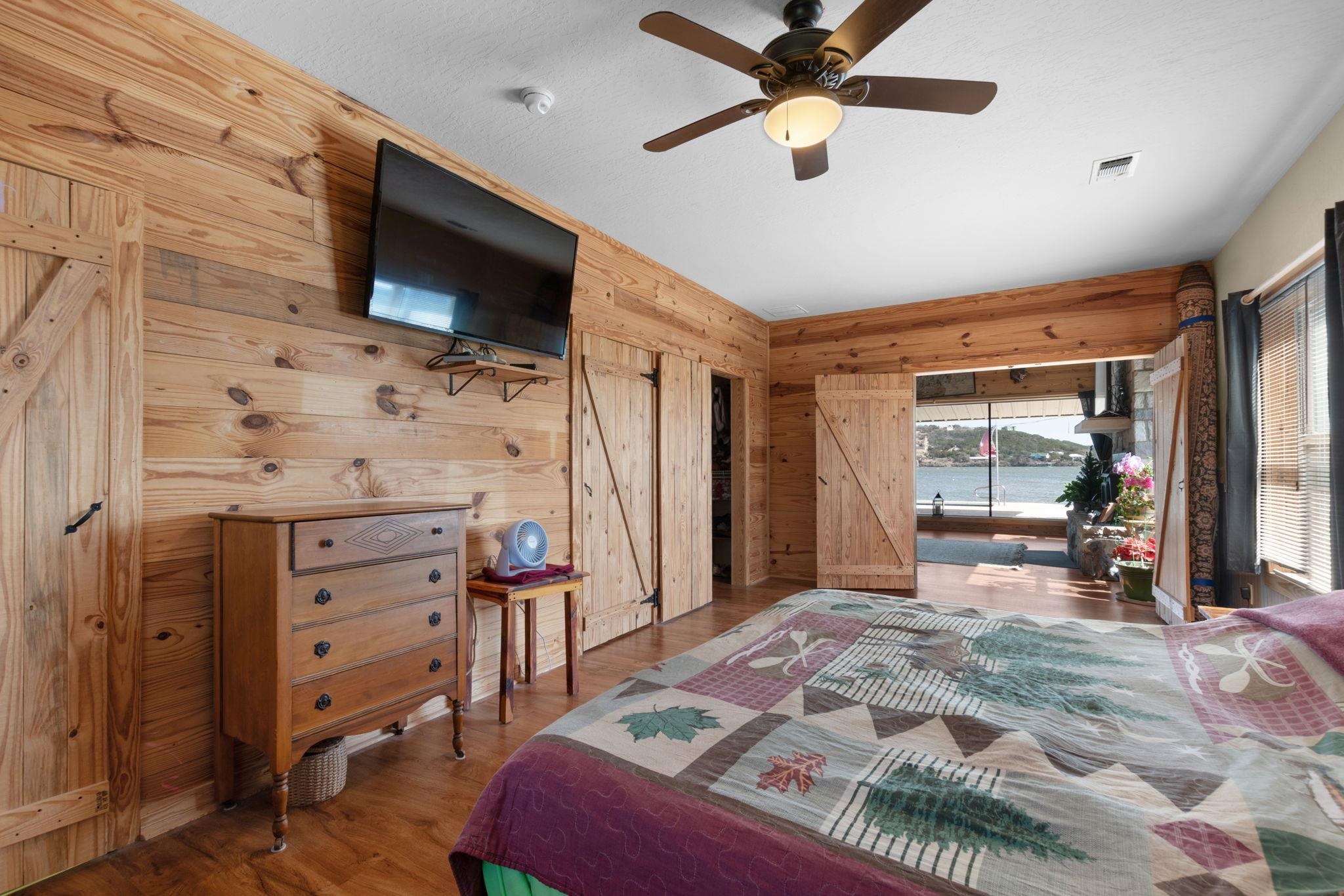 303 Lakeshore Loop Tow, TX 78672 - Photo 22 of 30 a bedroom with a bed and a flat screen tv