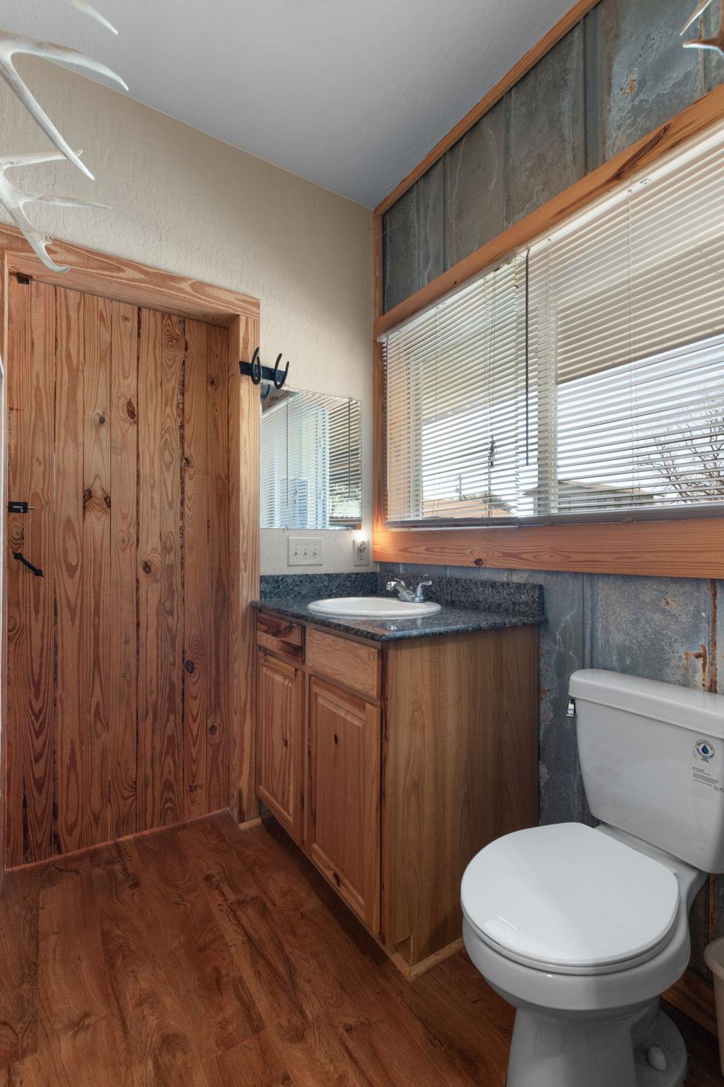 303 Lakeshore Loop Tow, TX 78672 - Photo 28 of 30 a bathroom with a granite countertop toilet sink and mirror