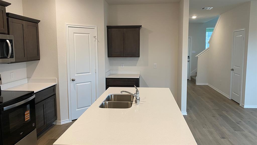 107 Hunters Way Canton, TX 75103 - Photo 4 of 23 a kitchen with a refrigerator and a sink
