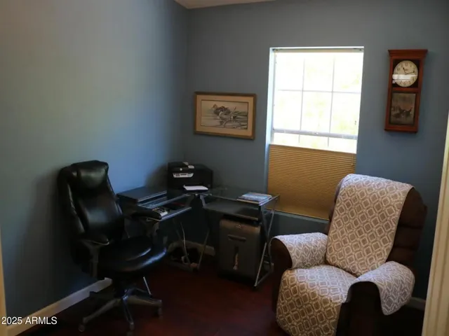 a livingroom with workspace and a couch