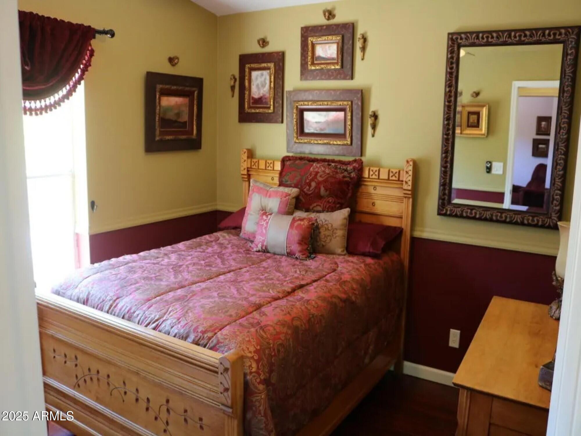 2322 Beasley Flat Road Camp Verde, AZ 86322 - Photo 14 of 27 a bedroom with a bed and wooden floor