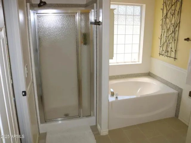 a bathroom with a tub and shower