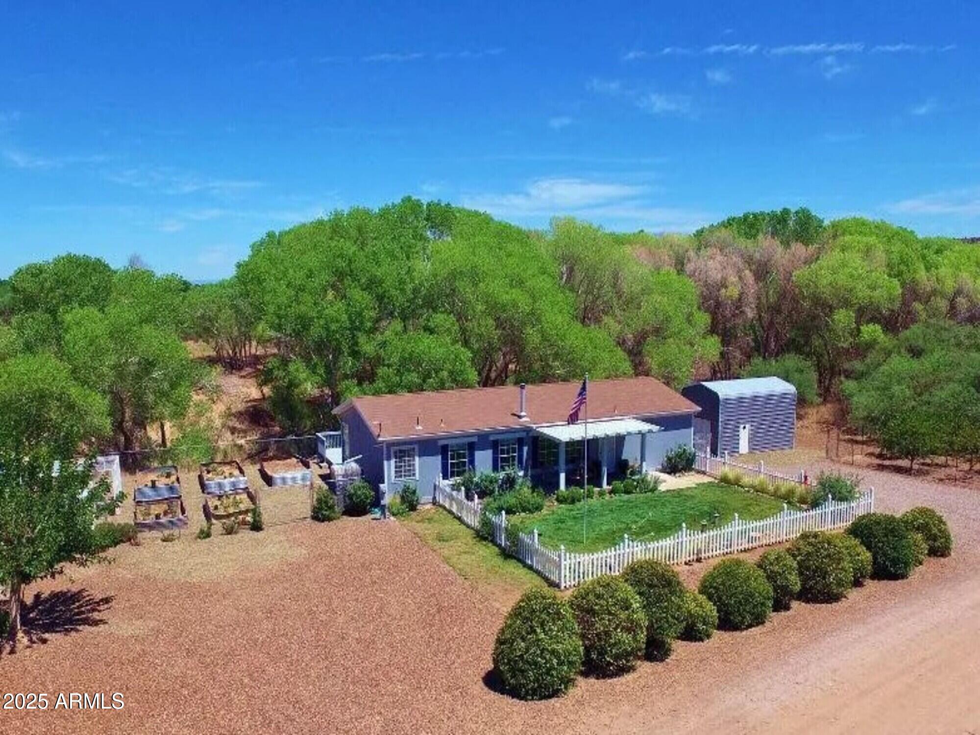 2322 Beasley Flat Road Camp Verde, AZ 86322 - Photo 2 of 27 a view of a big house with a big yard plants and large trees