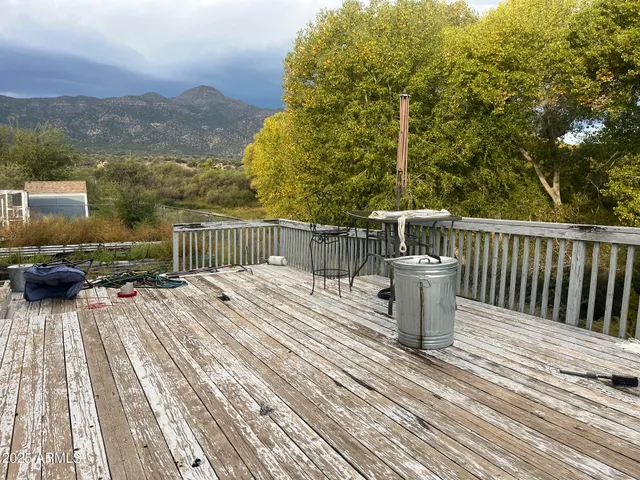 a view of backyard with deck and outdoor seating