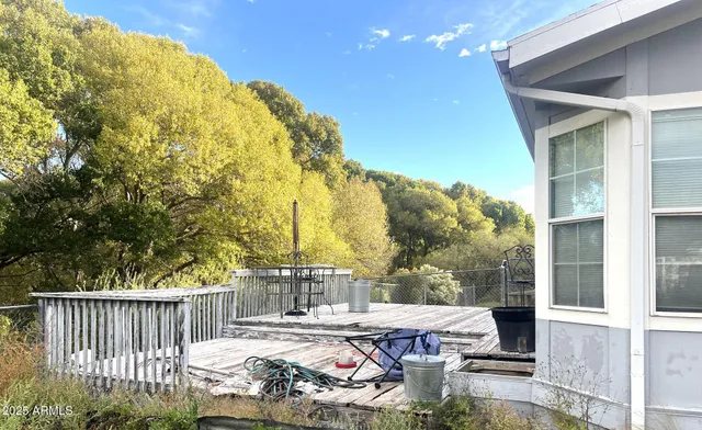 a view of a patio with table and chairs and floor to ceiling window