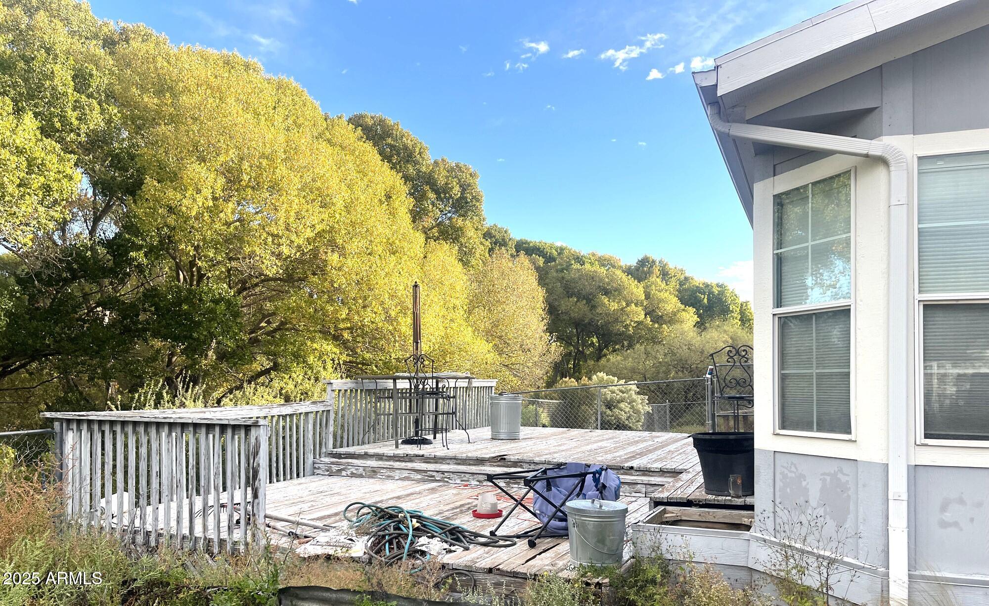 2322 Beasley Flat Road Camp Verde, AZ 86322 - Photo 26 of 27 a view of a patio with table and chairs and floor to ceiling window