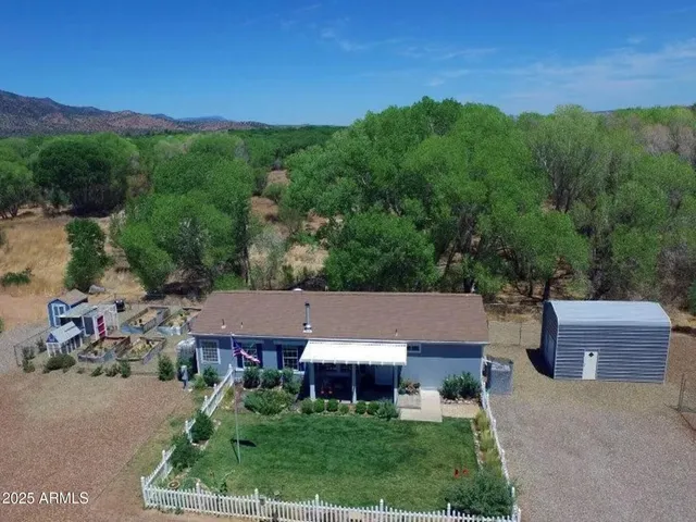 an aerial view of a house with a yard