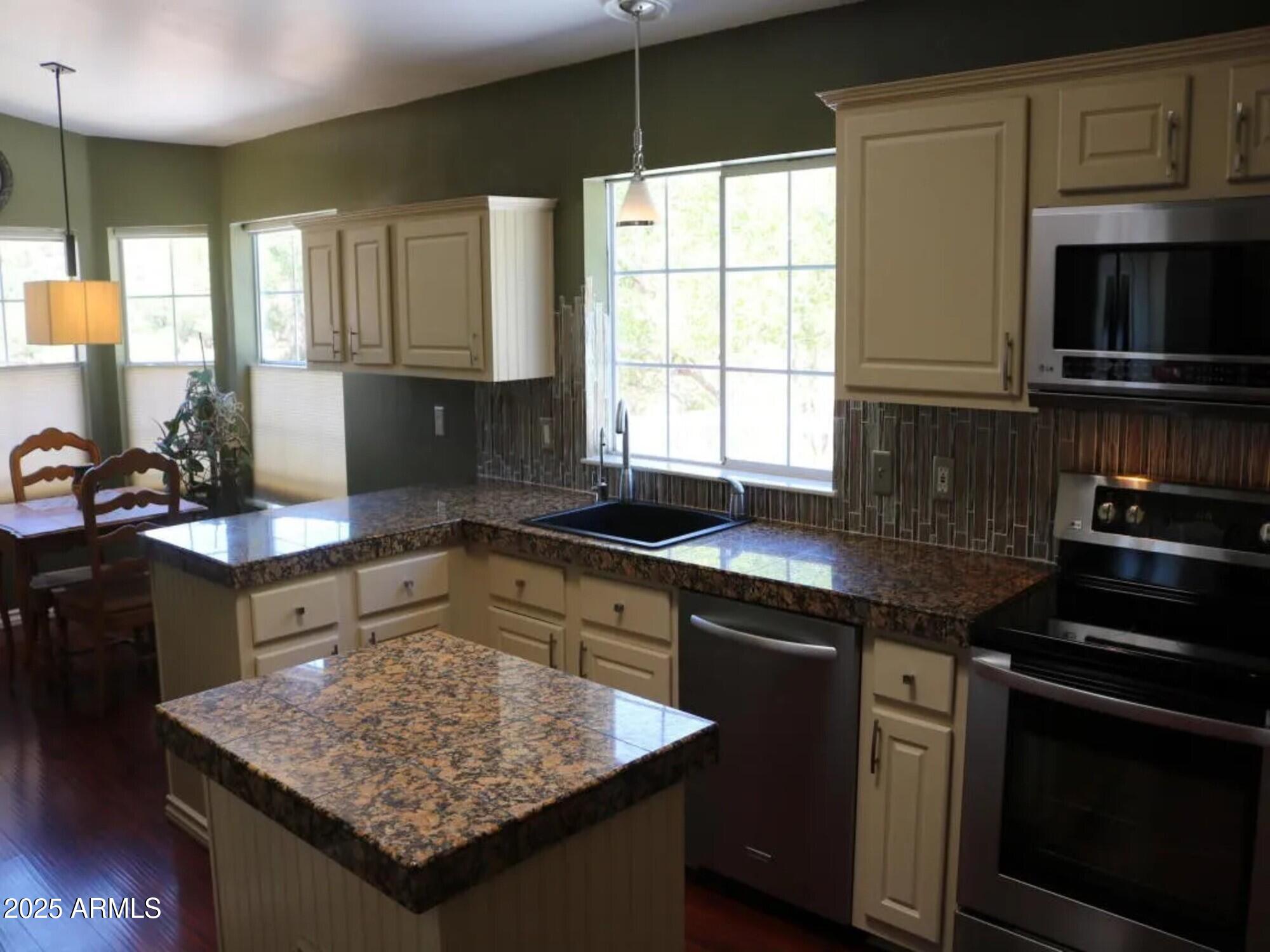 2322 Beasley Flat Road Camp Verde, AZ 86322 - Photo 8 of 27 a kitchen with stainless steel appliances granite countertop a sink stove and microwave