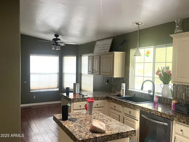 a kitchen with stainless steel appliances granite countertop sink stove and cabinets