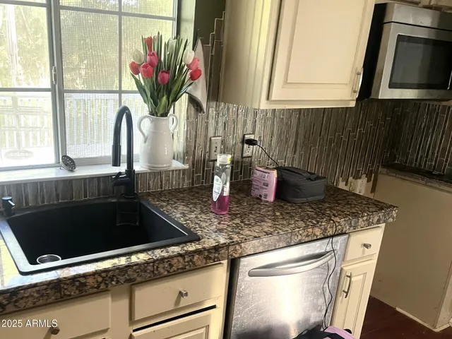 a kitchen with a stove a sink and a microwave