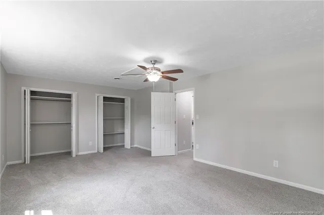 a view of an empty room with closet