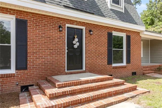 a view of a brick building with many windows