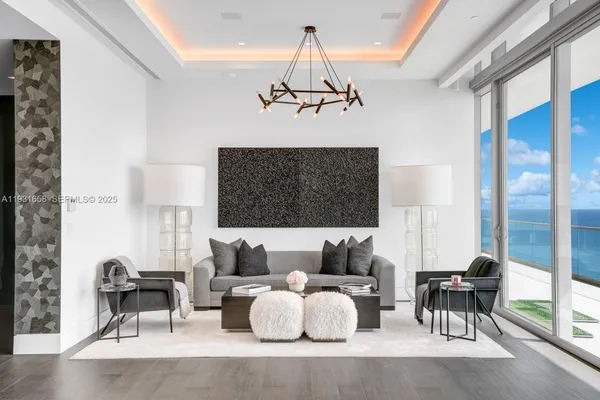 a living room with fireplace furniture and a floor to ceiling window