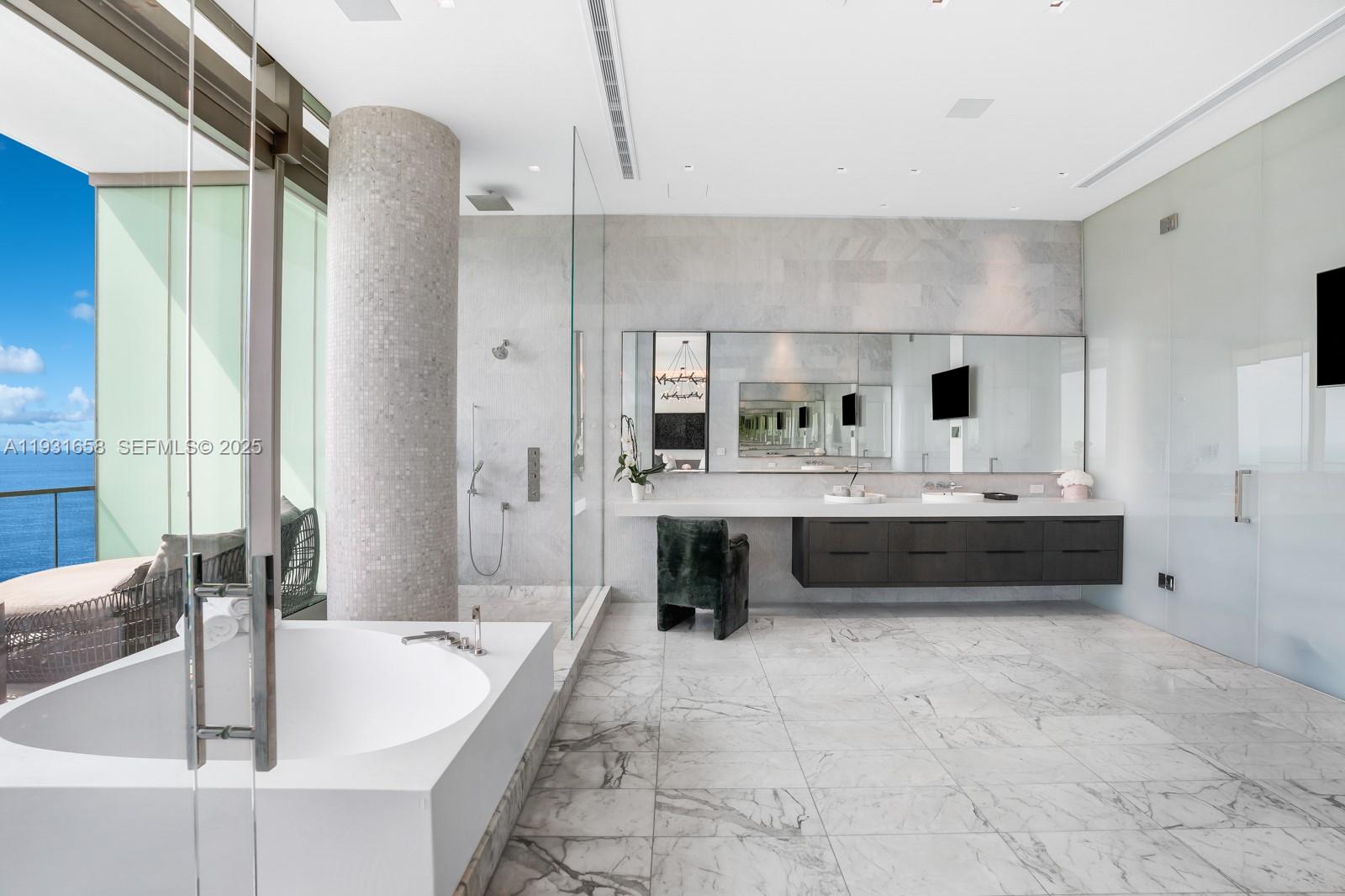 10203 Collins Avenue, Unit 2801 Bal Harbour, FL 33154 - Photo 19 of 60 a spacious bathroom with a double vanity sink a mirror and a bathtub