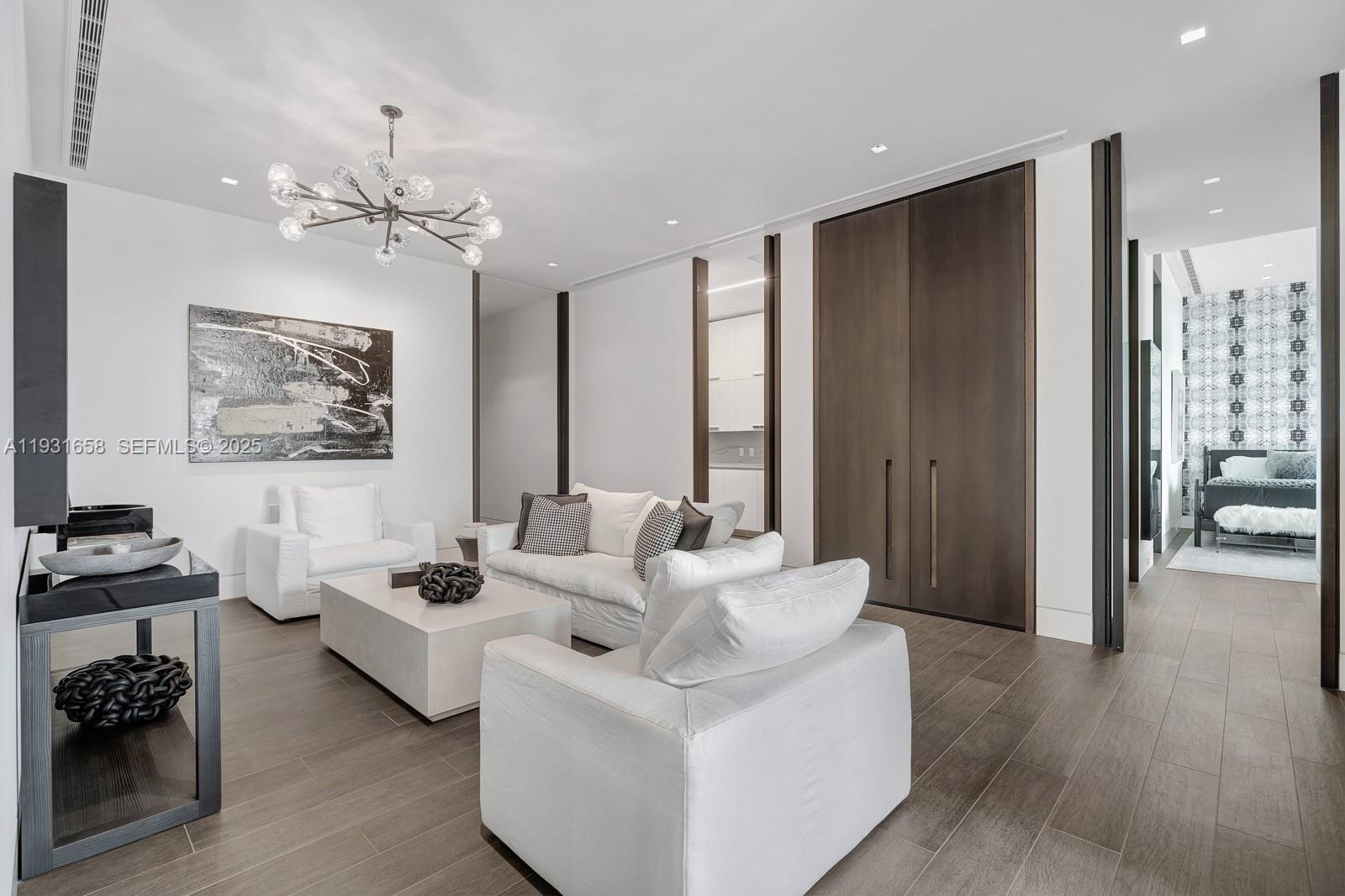 10203 Collins Avenue, Unit 2801 Bal Harbour, FL 33154 - Photo 42 of 60 a living room with furniture wooden floor and a chandelier