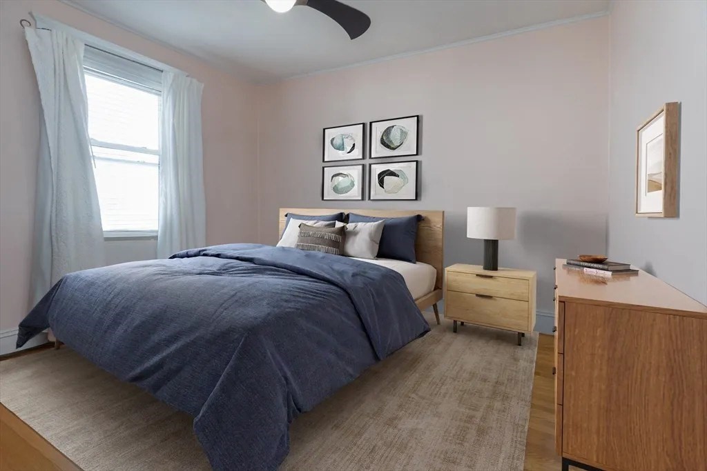 121 Johnson Street, Unit 3L Lynn, MA 01902 - Photo 6 of 10 a bedroom with a bed and window