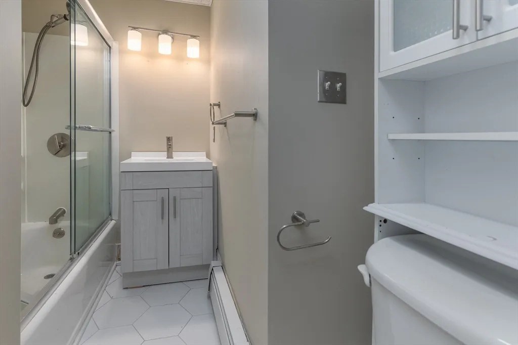121 Johnson Street, Unit 3L Lynn, MA 01902 - Photo 7 of 10 a bathroom with a sink a toilet and shower