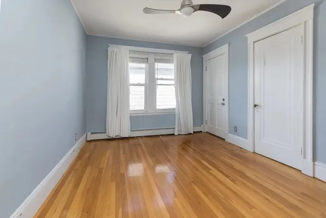 wooden floor in an empty room with a window