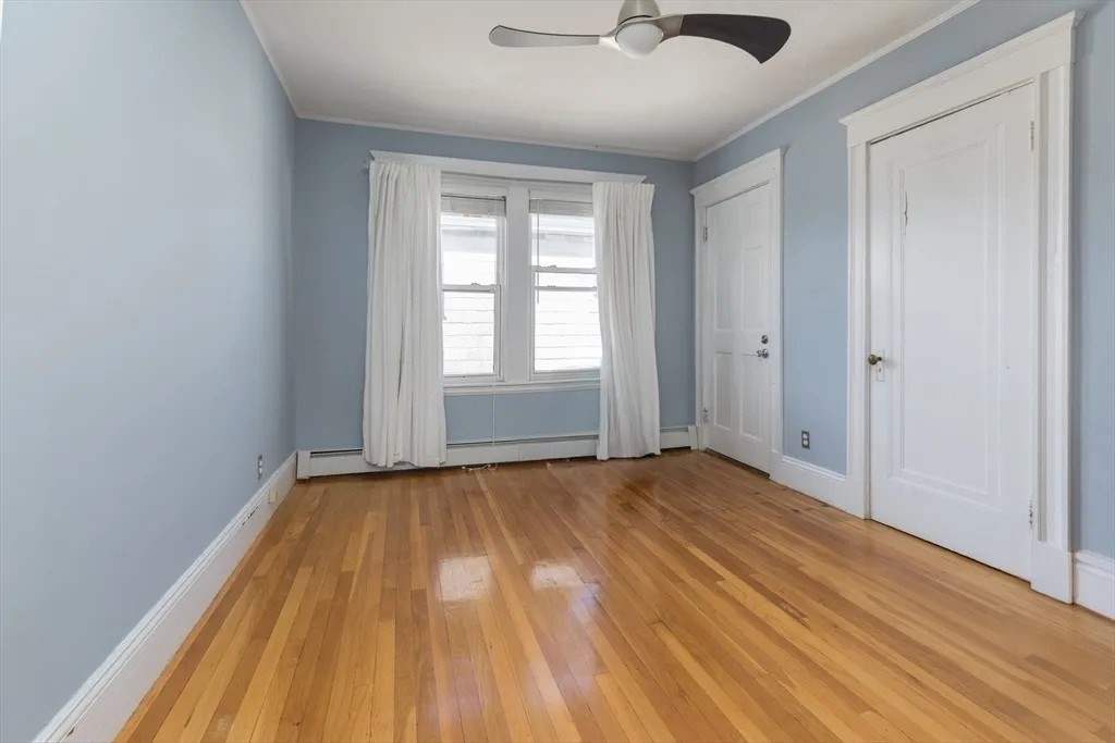 121 Johnson Street, Unit 3L Lynn, MA 01902 - Photo 8 of 10 wooden floor in an empty room with a window