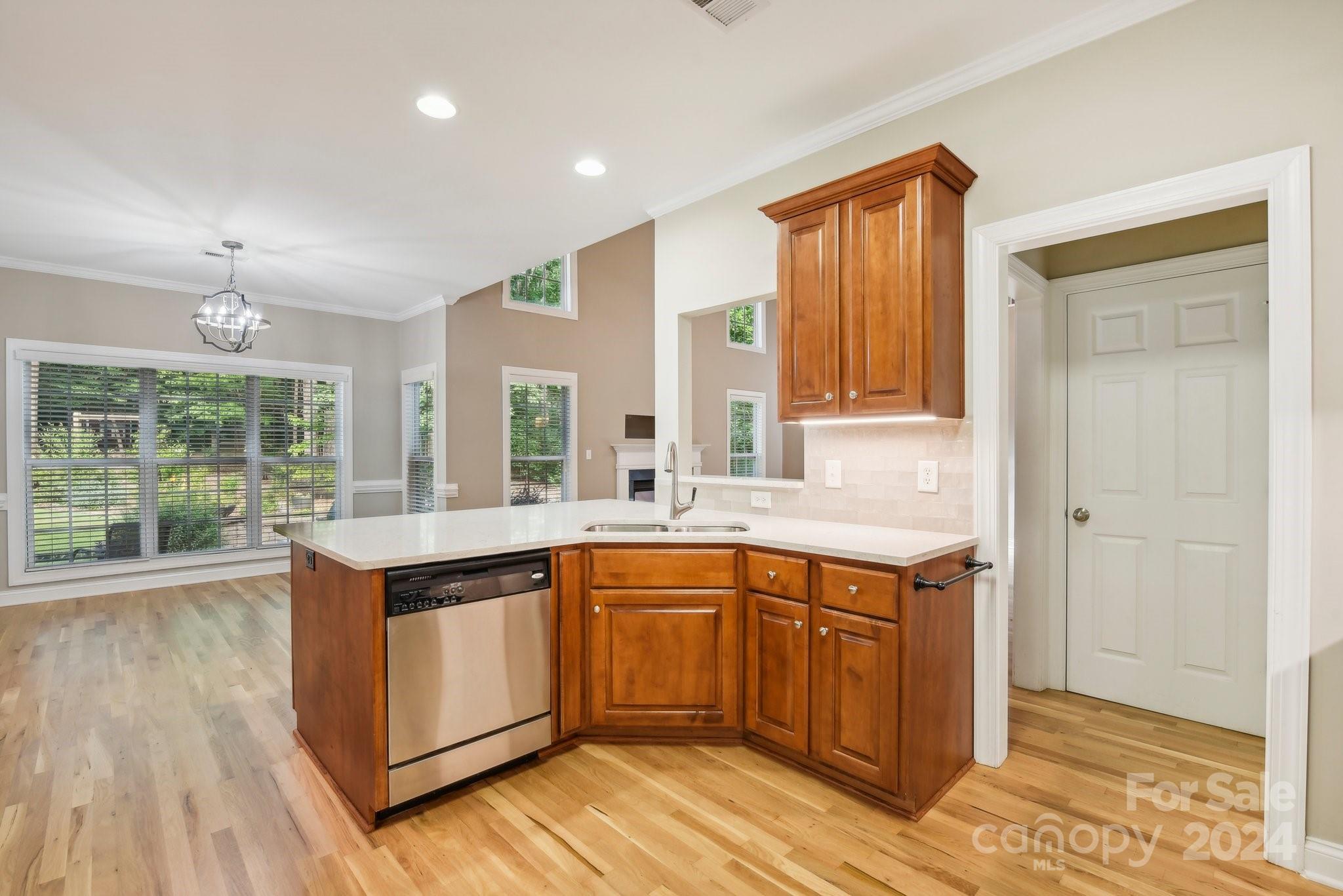 1013 Wesley Downs Road Monroe, NC 28110 - Photo 13 of 41 a kitchen with a sink stove and wooden cabinets