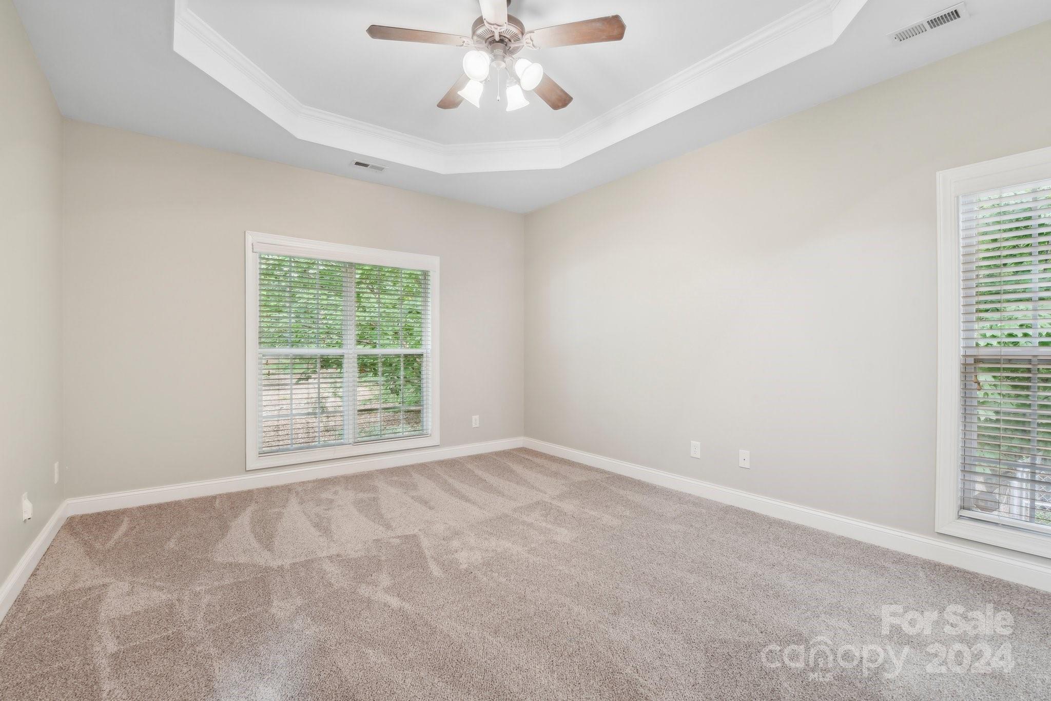 1013 Wesley Downs Road Monroe, NC 28110 - Photo 18 of 41 an empty room with windows and fan