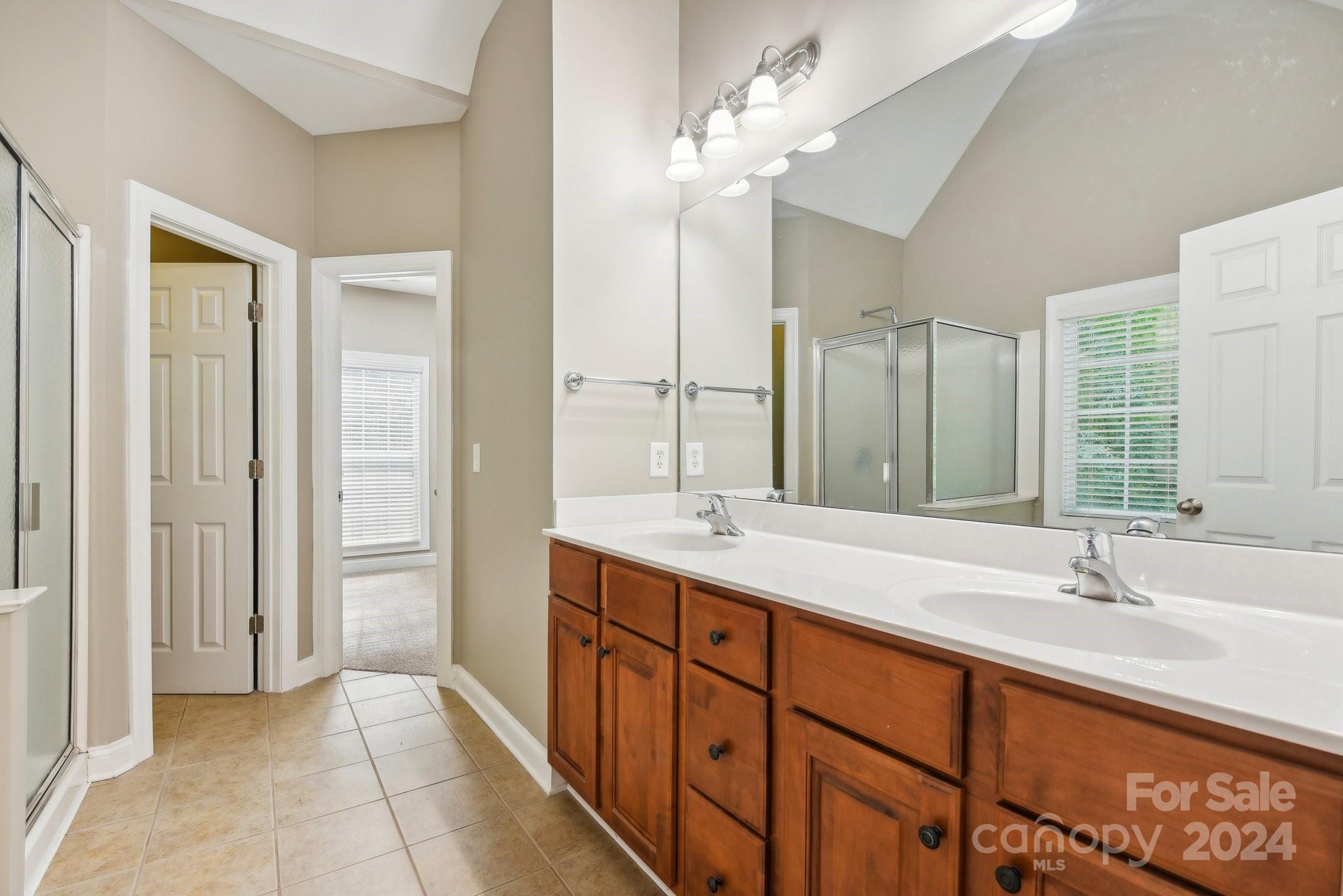 1013 Wesley Downs Road Monroe, NC 28110 - Photo 19 of 41 a bathroom with a double vanity sink and a mirror