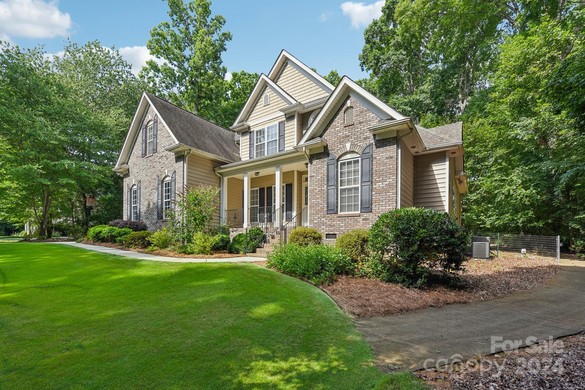 1013 Wesley Downs Road Monroe, NC 28110 - Photo 2 of 41 a front view of a house with a yard and green space
