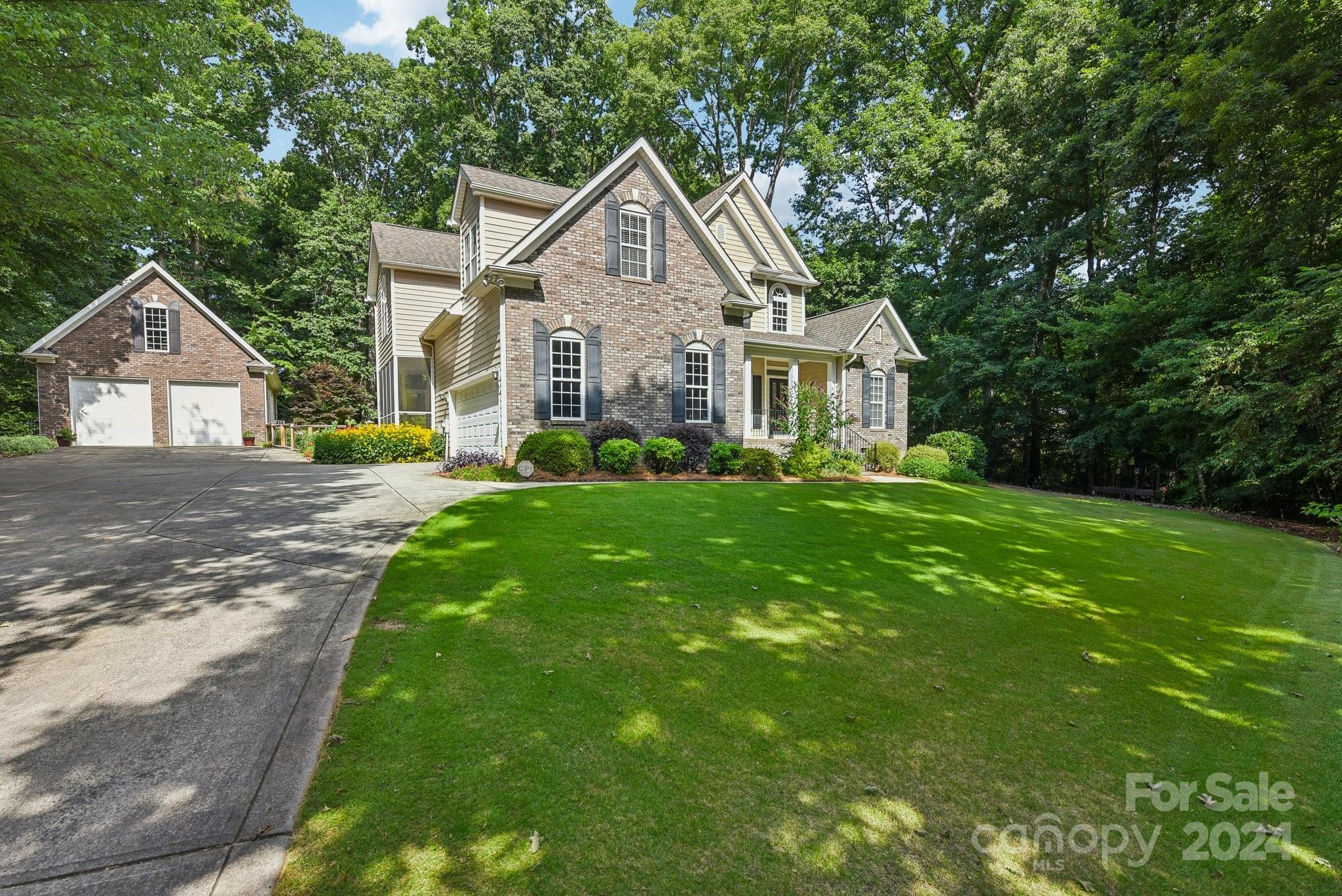 1013 Wesley Downs Road Monroe, NC 28110 - Photo 3 of 41 a front view of a house with a yard and trees