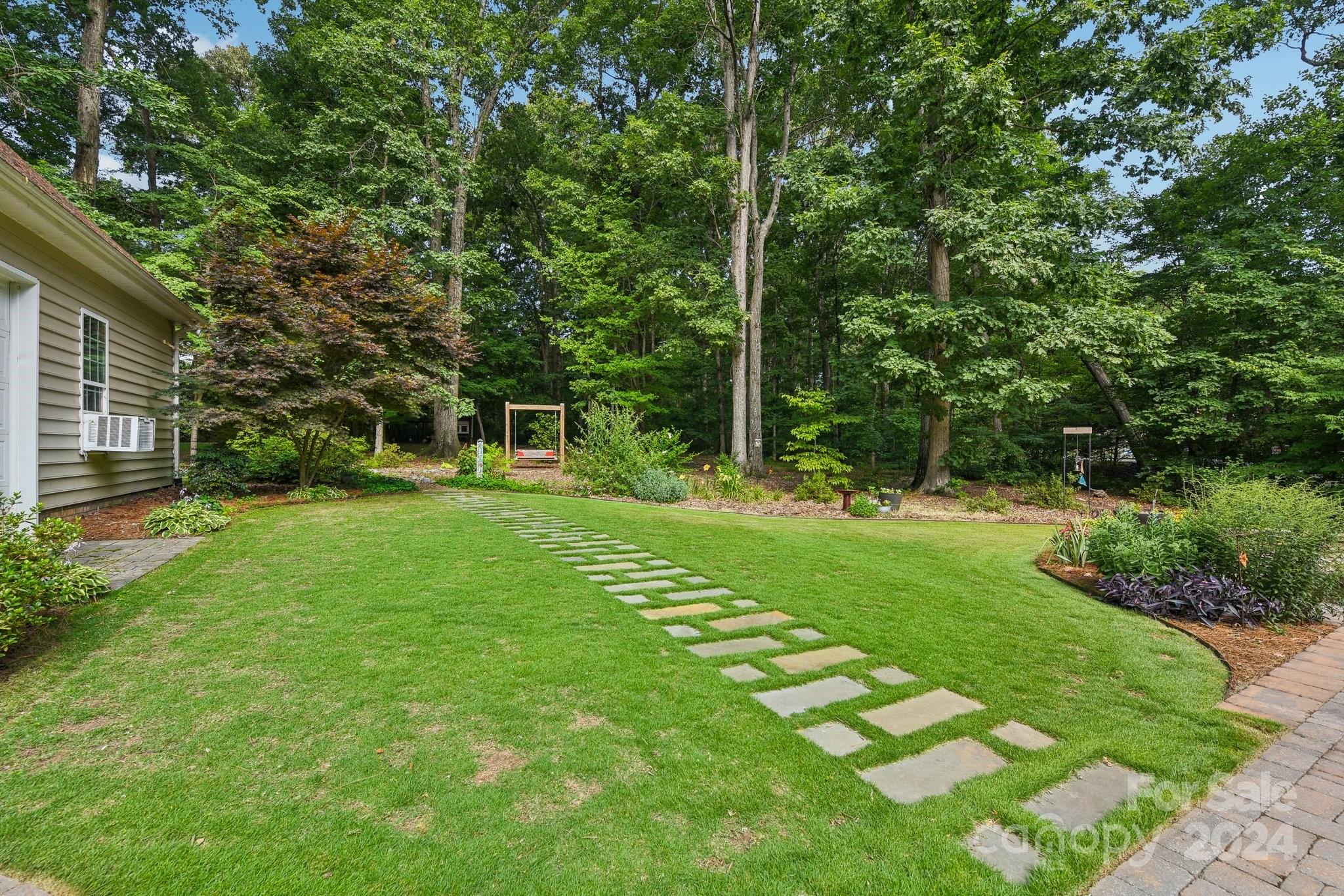 1013 Wesley Downs Road Monroe, NC 28110 - Photo 33 of 41 a view of a backyard with a garden