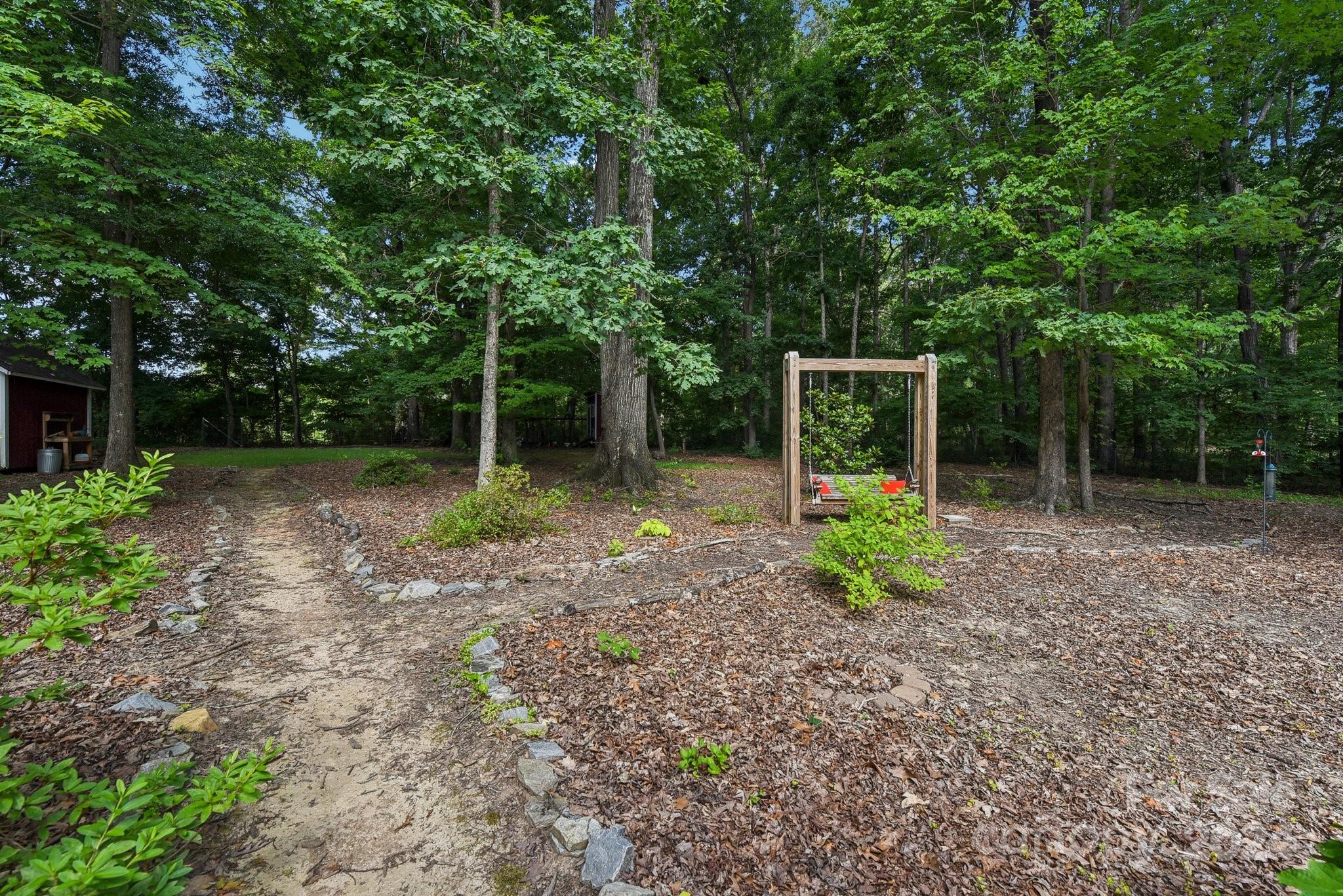 1013 Wesley Downs Road Monroe, NC 28110 - Photo 37 of 41 a view of an house with backyard space and garden